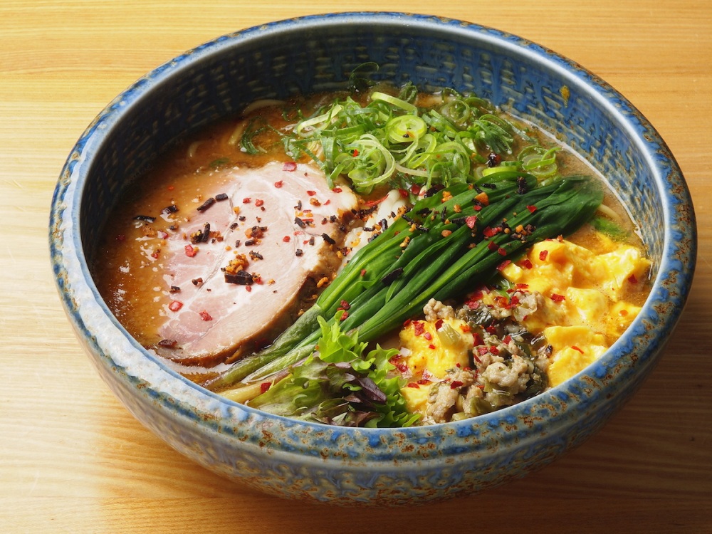 The prominently featured alpine leek goes great with the slightly salted scrambled egg in the “bowl that lift your spirits” at Ramen Sapporo Ichiryuan.